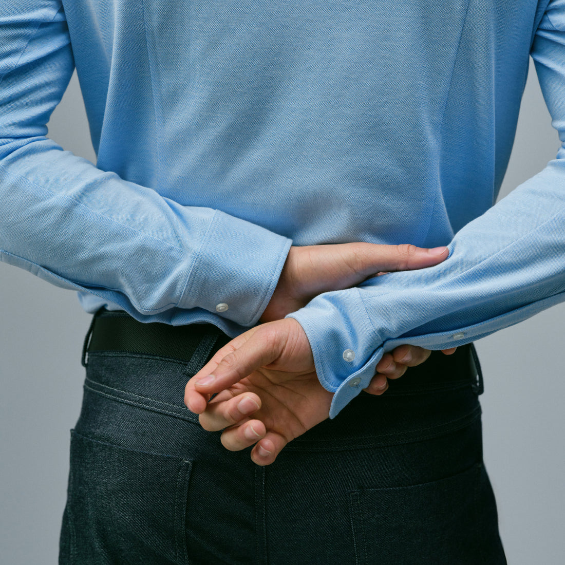 back of a man wearing a long sleeve baby blue SILVER button up