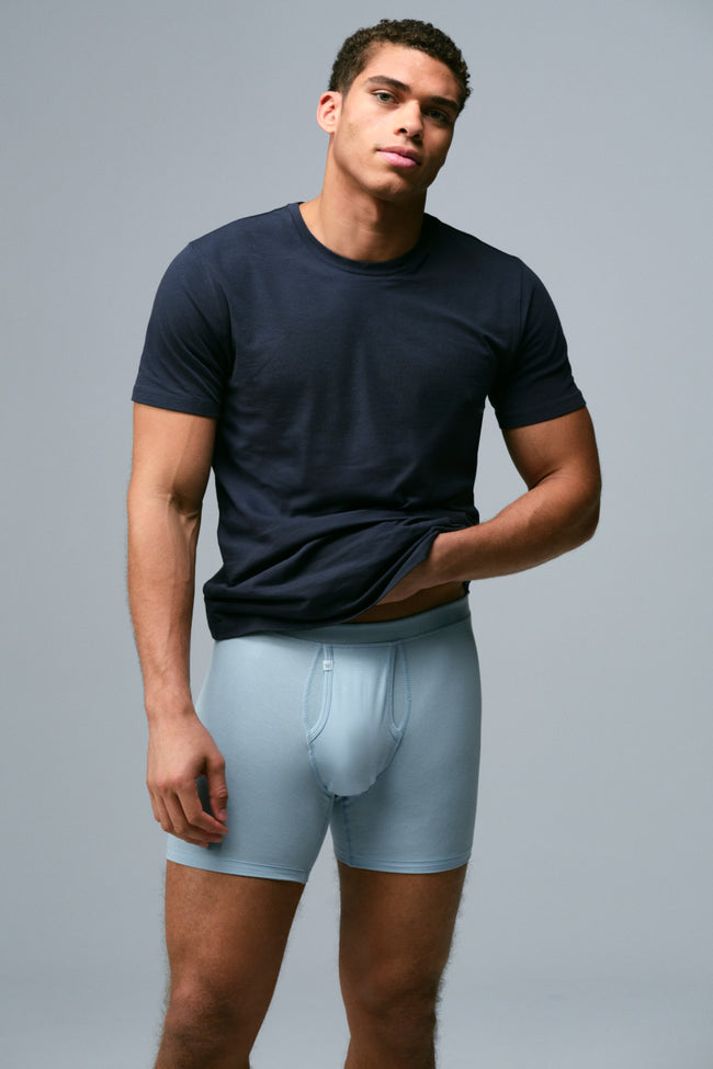 Man wearing a navy blue SILVER crew neck t-shirt and baby blue SILVER boxer briefs
