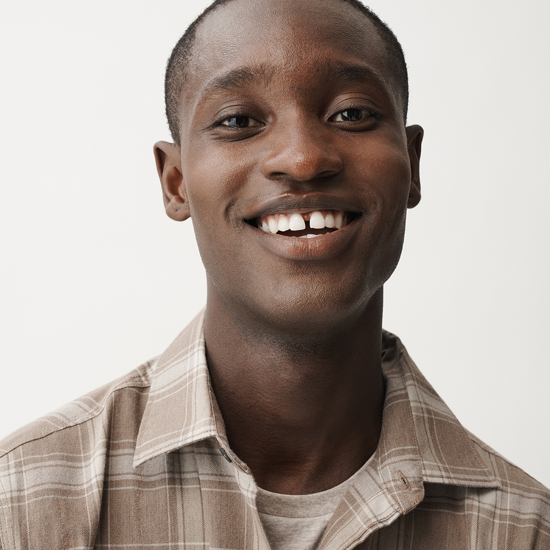 Man smiles and is wearing a WARMKNIT button up