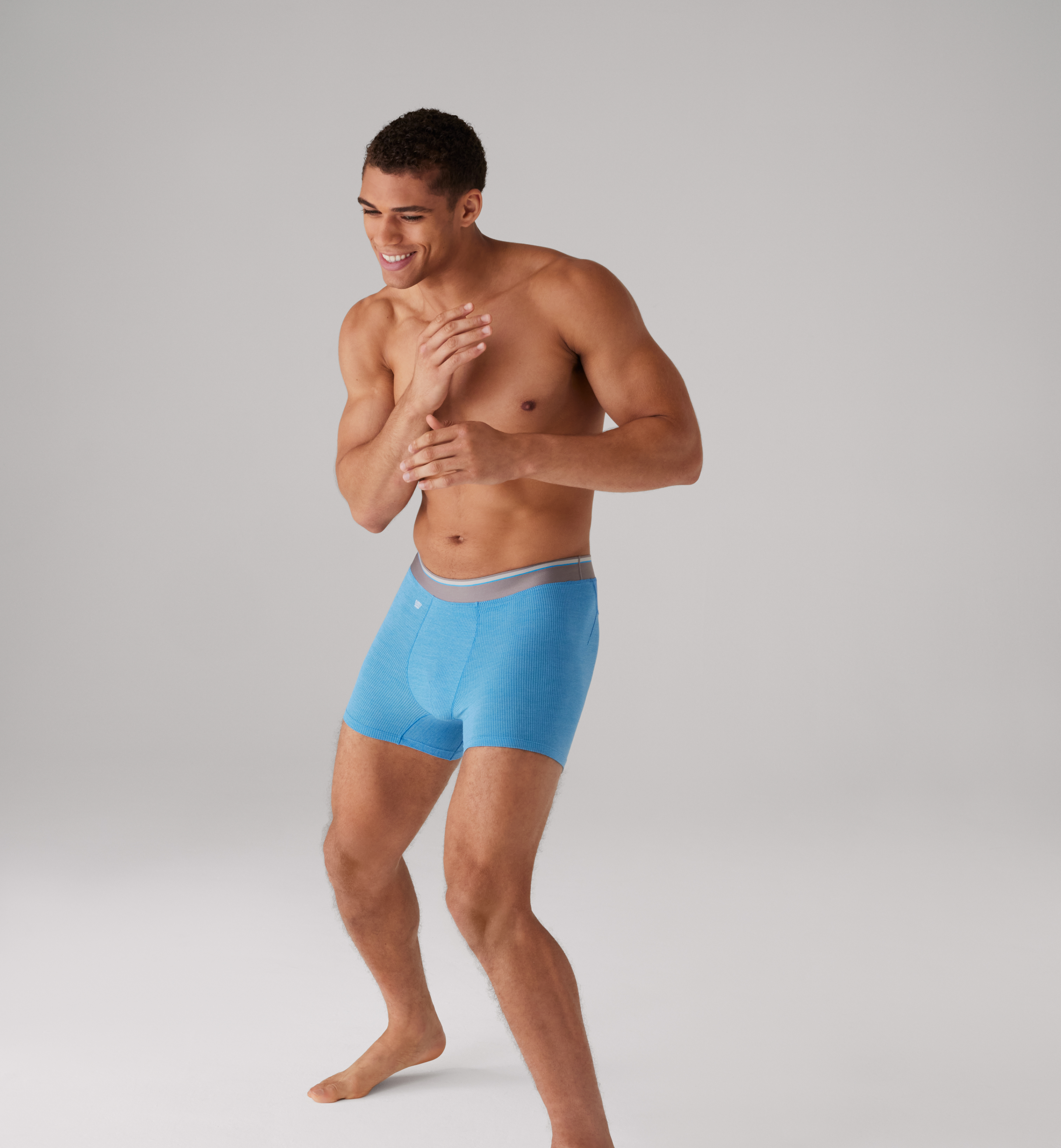 Image of a man wearing blue AIRKNITx boxer briefs